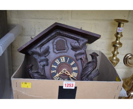 An old cuckoo clock, with pine cone weights and pendulum. 