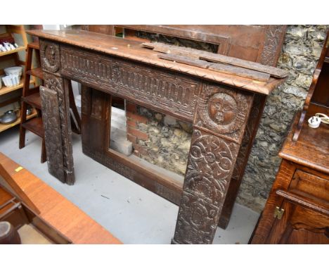 An interesting French carved oak fire surround, containing 16th/17th century elements, the frieze 137.5cm wide.See lots 1119 