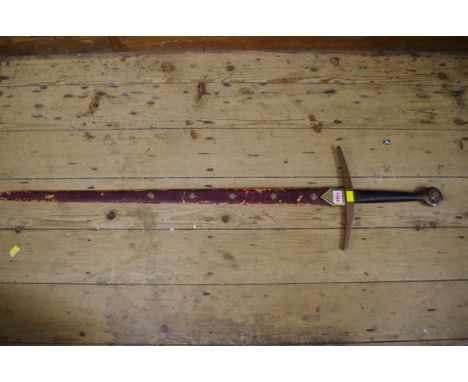 An old Norman style sword and brass mounted leather scabbard,&nbsp;the blade 91cm long.&nbsp; 