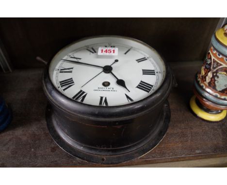 A World War II period black painted Smiths bulkhead timepiece,Â&nbsp;with 6Â½in enamel dial. 