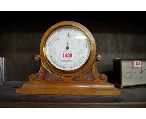 An oak mantel barometer,&nbsp;with enamel dial, 19cm high. 