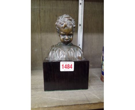 A circa 1900 bronze bust of a boy, 11cm high, on ebonized base. 