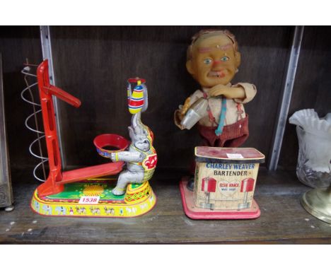 A 'Made in Japan' tin plate automaton bartender;Â&nbsp;together with a 'Made in Germany' tin plate clockwork example. 