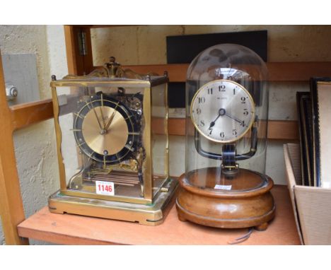 A vintage electro magnetic 800 day timepiece, with glass dome, total height 26cm; together with a Schatz brass mantel clock, 