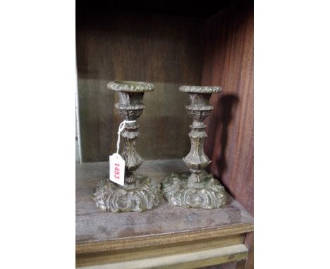 A pair of antique cast bronze candlesticks,Â&nbsp;16.5cm high. 