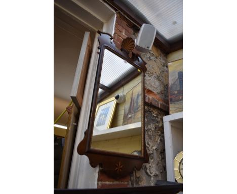 A reproduction mahogany framed wall mirror,&nbsp;105cm high x 56cm wide.&nbsp; 