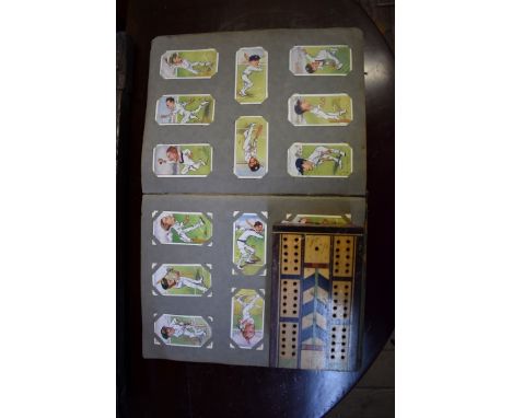 An album of cigarette cards;Â&nbsp;together with a parquetry cribbage board. 
