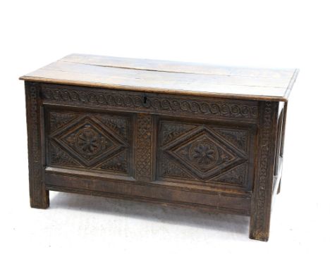 19th century oak trunk, with carved floral decoration on square feet, H63 x W115cm 