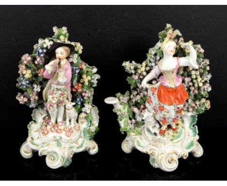 Porcelain bocage figure of a boy playing a pipe, and another of a girl picking flowers, on scroll base, approx h20cm