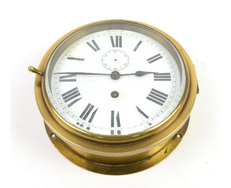 Brass bulkhead clock, the white enamel dial with Roman numerals and outer minute track, subsidiary seconds dial at 12, spade 