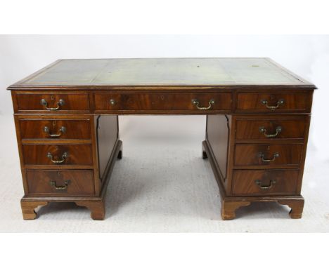 Late 19th/Early 20th Century mahogany pedestal desk with green leather top of three drawers over further drawers to bracket b