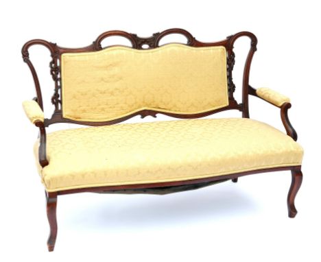 19th century mahogany sofa, with shaped and floral carved top rail and scroll arms, having floral upholstery, on cabriole leg