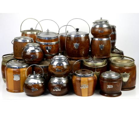 A large collection of 20th century treen wooden biscuit barrels and tea caddies of barrel form, most with swing handles and c