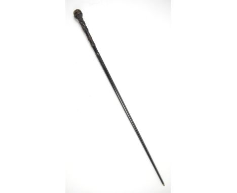 Early 20th century swordstick with carved ebonised handle in tubular black metal sheath, 94cm long, 