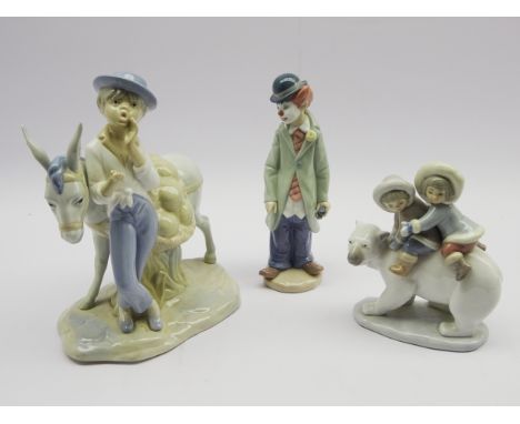 Three Lladro figures 'Eskimo Riders', 'Circus Sam' & a boy with Donkey, H26cm (3) Condition Report & Further Details Good con