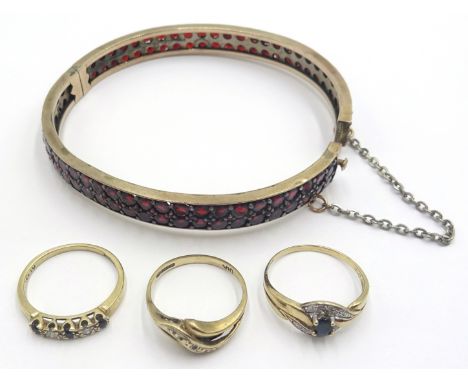 Garnet set hinged bangle unmarked, two sapphire and diamond rings and a diamond ring hallmarked 9ct Condition Report & Furthe