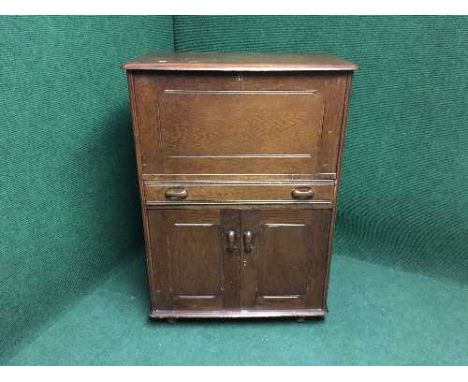 An Ercol oak cocktail cabinet