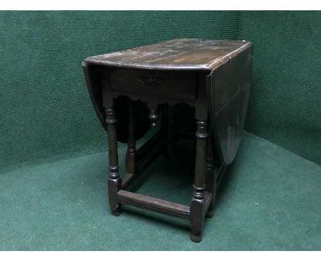 A late 19th century oak gate leg table fitted a drawer 