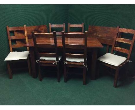 A contemporary hardwood dining table with extension leaves together with a set of six ladder backed chairs