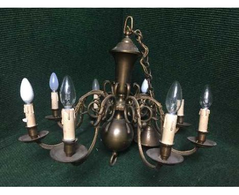 A brass eight way light fitting 