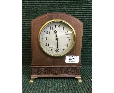 A mahogany mantel clock on brass bracket feet 