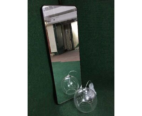 A contemporary framed hall mirror together with a light fitting