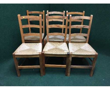 A set of six pine rush seated ladder backed chairs