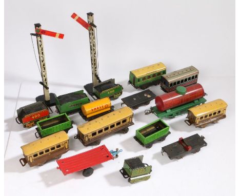 Collection of tinplate model railway carriages and rolling stock, to include Baxtoy and Chad Valley, together with two signal