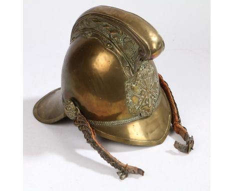 A 19th Century brass fireman's helmet, with crossed axe and entwined hoses emblem to the front