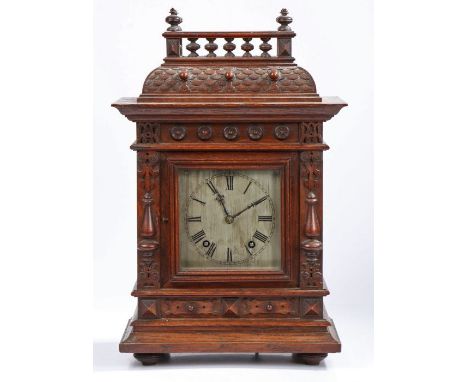 Early 20th century oak cased mantle clock, the architectural case with a single glazed door enclosing a silvered dial with ro