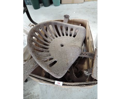 A vintage cast iron farm implement or tractor seat and cast fitments