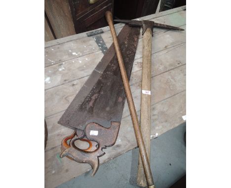 A selection of vintage tools and cane including pick axe