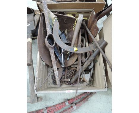 A selection of vintage cast iron tools and hay fork