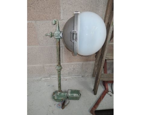 A vintage wall mounted light with bracket