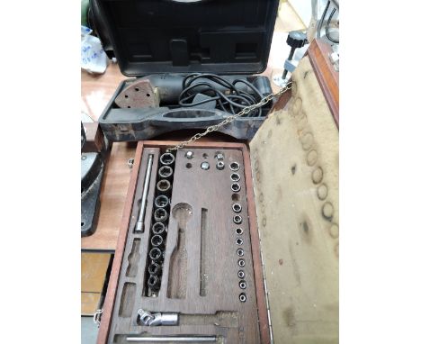 An impact socket set in wooden box and sander