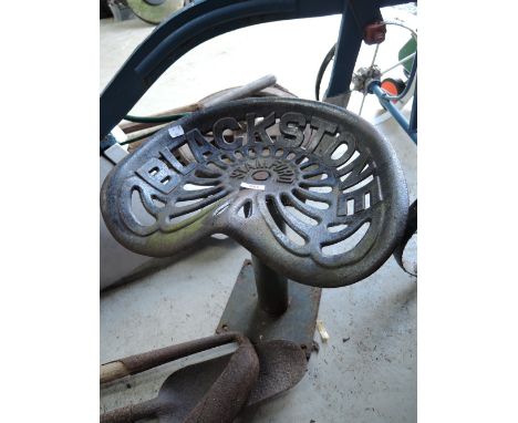 A vintage farm implement or tractor seat