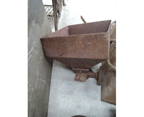 A vintage cast iron grain hopper