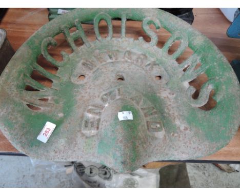 A vintage farm implement or tractor seat