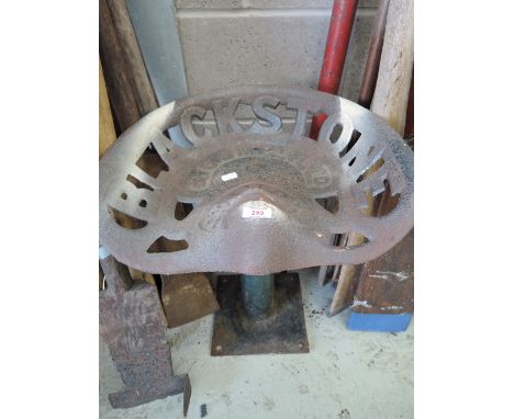 A vintage farm implement or tractor seat