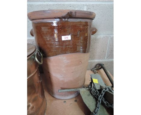 A vintage ceramic water filter or ventilated container
