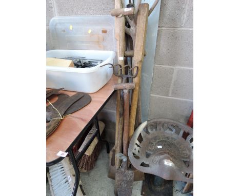 A selection of vintage farm tools peat spades and hay fork