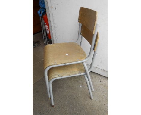 Nine vintage tubular metal framed school chairs with plywood backs and seats