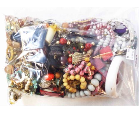 A bag containing a quantity of assorted vintage and later costume jewellery
