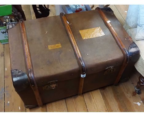 A 76cm vintage wooden bound travelling trunk with leather bound corners and internal tray