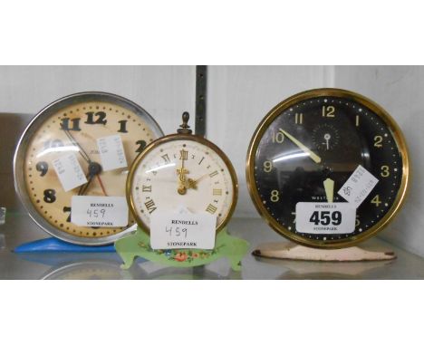 Three vintage alarm clocks comprising decorated green painted metal, blue and white examples - various condition