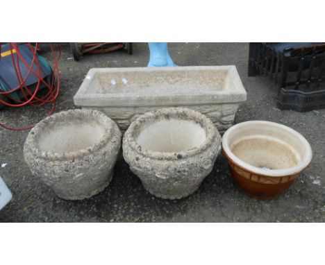 A concrete oblong planter with tapered sides - sold with a pair of circular concrete planters and a glazed ceramic pot