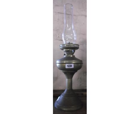 A vintage brass oil lamp with glass shade