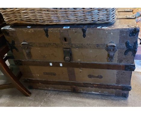 An 87cm antique wood bound cabin trunk with iron hardware and flanking leather strap handles
