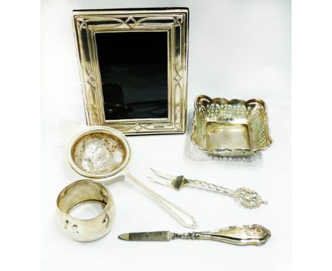 A small modern silver fronted photograph frame with upholstered easel back - sold with a silver bon bon dish, tea strainer, n