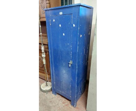 A 54cm vintage blue painted freestanding cabinet with shelves enclosed by a panelled cupboard door